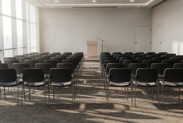 Fototapeta premium Empty modern conference room with chairs, podium, and bright natural light.