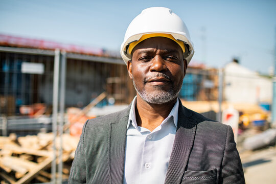 Mature construction manager wearing hard hat at building site