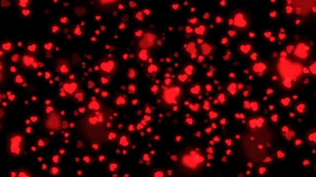 A vibrant animation featuring countless red heart particles gracefully ascending against a deep black backdrop, creating a beautiful bokeh effect.