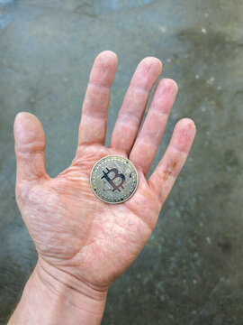 Close-up of Bitcoin Coin Held in Open Palm