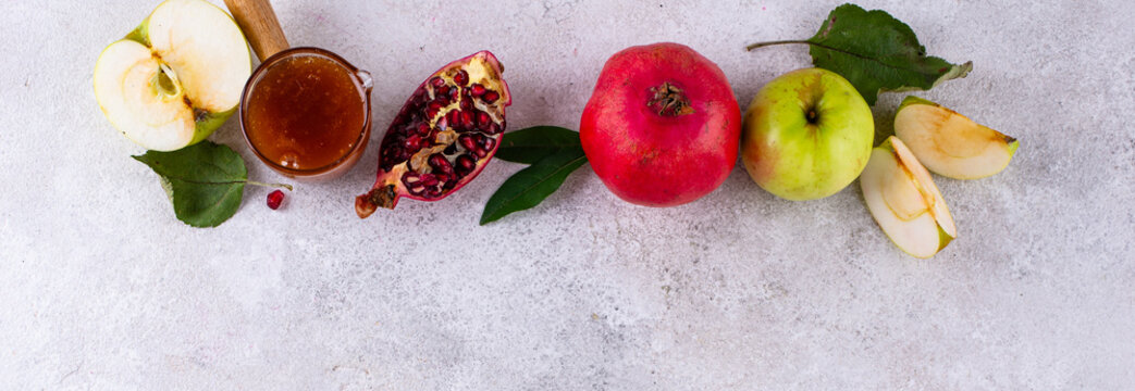 Rosh Hashana Jewish New Year concept with honey apple and pomegranate