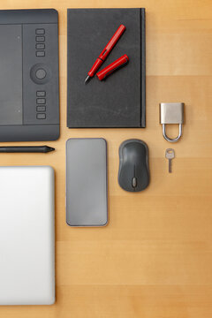 Vertical top view of secure technology workspace with laptop and smartphone