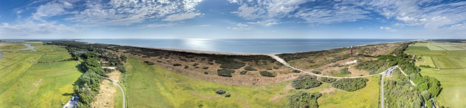 Aerial panorama of Dutch coast with dunes sea and red lighthouse
