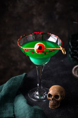 Fototapeta premium Spooky green Halloween monster cocktail with eyeball