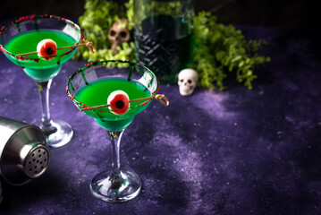 Fototapeta premium Spooky green Halloween monster cocktail with eyeball