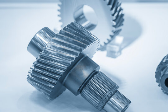 Incline scene of precision bevel gear shaft parts in dramatic blue tone lighting