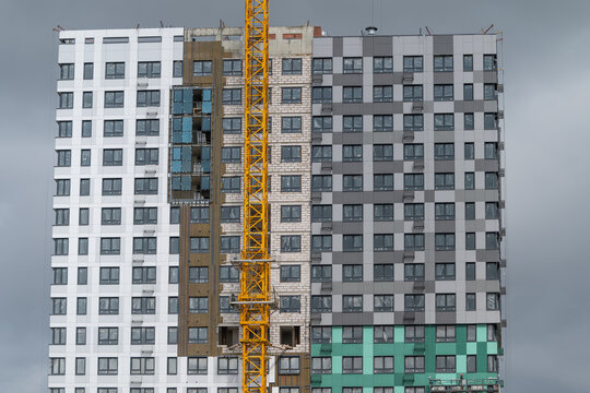 Construction of a modern high-rise building showcasing architectural progress and urban development in a bustling city