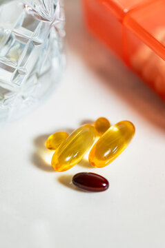 Different pills or vitamins near Weekly Pill Box, Daily Portable Travel Pill Box Organiser