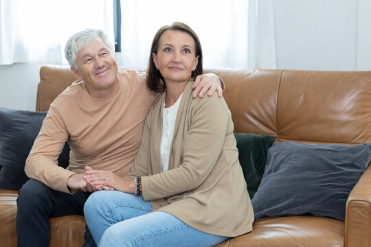 An elderly couple spends time together in living room