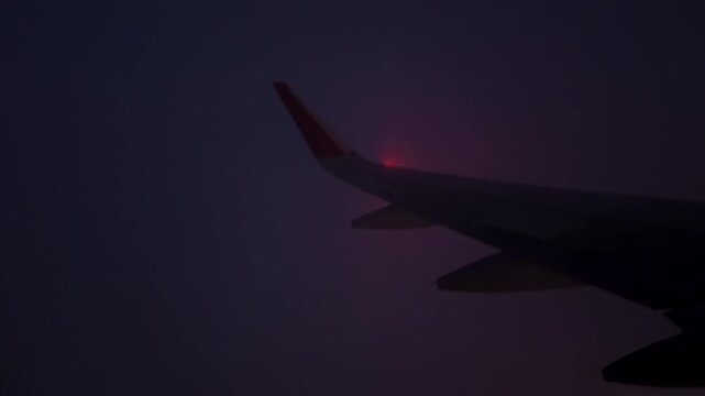 Airplane Wing Over Cloudscape At Sunrise With Golden Horizon Light and In-Flight Viewю Flying Through a Cloud 