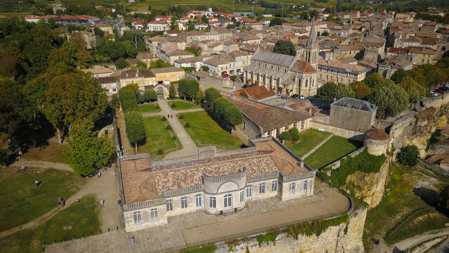 Aerial view of the historic manor, gardens, and church spire in the town of Bourg sur Gironde, Bourg, Nouvelle-Aquitaine, France.