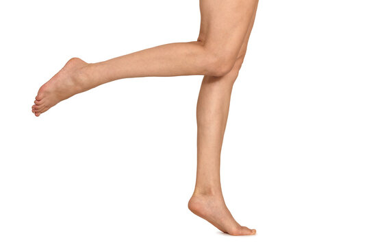Slender long female legs in walking pose, isolated on white background. Reference to human anatomy.