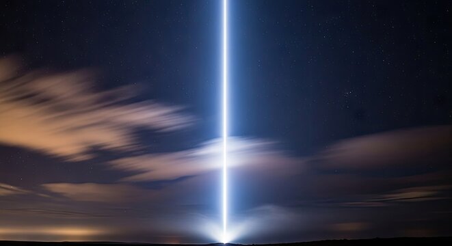 Single bright vertical light beam shining into night sky.