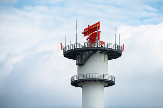 Radar tower at Frankfurt Main Airport, Germany, equipped with  distinctive orange Airport Surveillance Radar system, ASR antenna for monitoring airspace, air traffic control