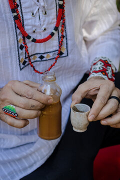 Sao Paulo, SP, Brazil -junho 20 2023: Person serving Ayahuasca, a traditional indigenous beverage details.