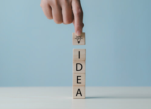New business ideas and strategic consulting. Mobile wooden block with light bulb icon. Brainstorming creativity and expertise.