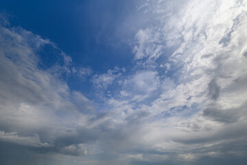 Obraz premium Endless expanse of clouds dances across a vibrant blue sky during a tranquil afternoon