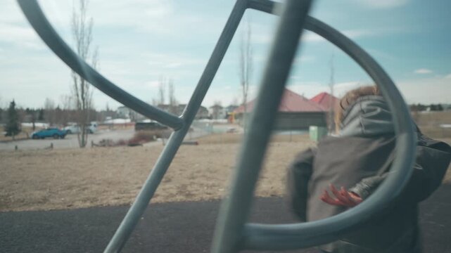 Boy running with motion blur near playground then smiling in profile close-up