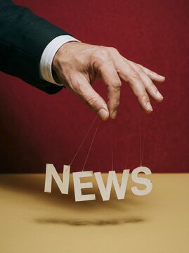 Hand in suit controlling news with puppet strings symbolizing media manipulation
