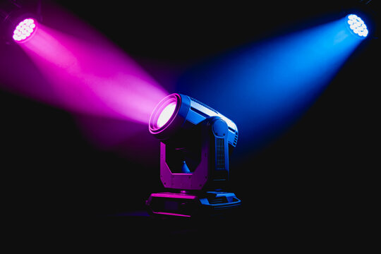 Professional stage moving head LED lights emit vibrant pink and blue beams in a dark indoor performance space, designed for event and show lighting.