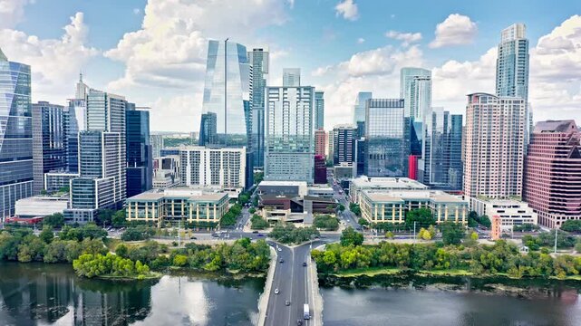 Aerial establishing shot of Austin, Texas skyline with slow camera uptilt, along Colorado river. Austin is the capital city of the U.S. state of Texas.