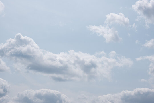 Clouds in the sky on a sunny afternoon with varying shapes and sizes creating a soft atmosphere
