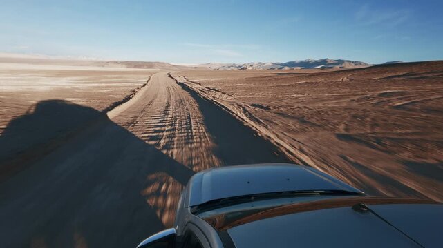 Offroad SUV Pick Up Truck driving through Campo de Piedra Pomez in Catamarca Argentina Front Hood POV sunrise - Drone flying, Aerial view