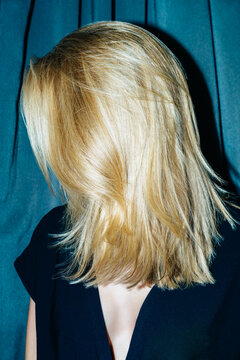 Blonde woman with face hidden by hair