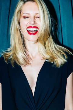 Laughing blonde woman with eyes closed