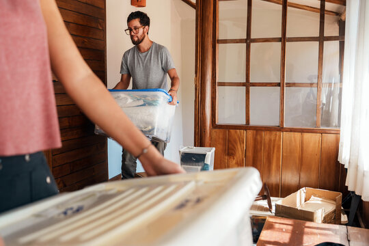 Couple Carrying Boxes While Moving In 