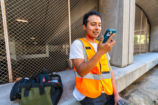 construction worker in city using smartphone