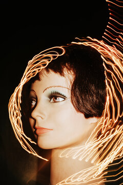 Mannequin Head With Light Trails in a Dark Background
