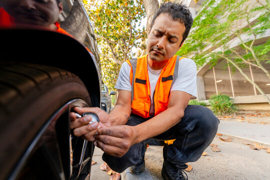 checking tire pressure with gauge