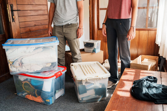 couple in messy room with moving boxes