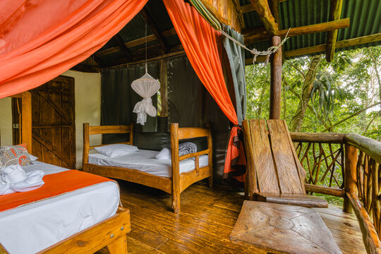 Rustic eco lodge bedroom with jungle view balcony