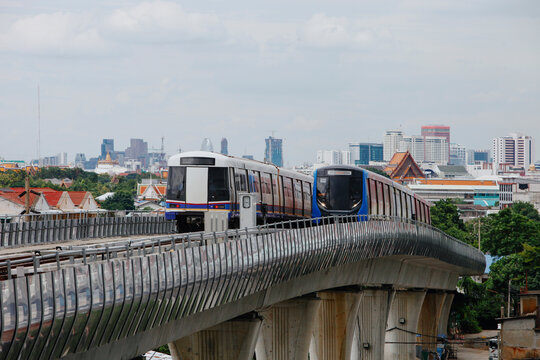 Skytrains Travel on an elevated track in Urban Area During Afternoon