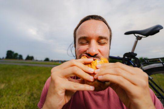 Man Eating Muffin Outdoors