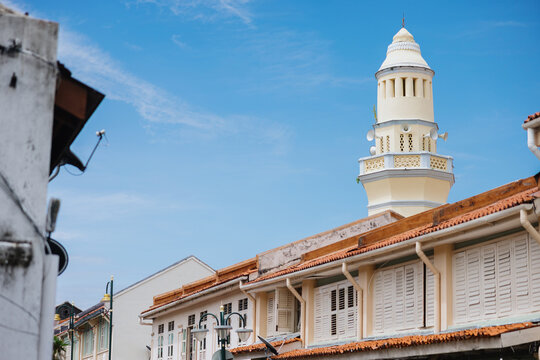 Historic Mosque Minaret Rising Above Colonial Shophouses