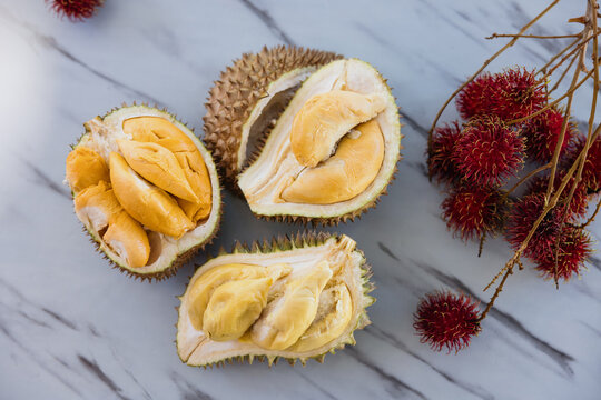 Fresh durian and rambutan tropical fruits on marble table