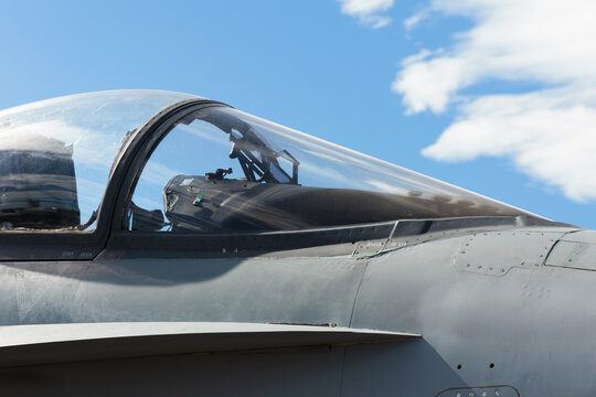 Fighter plane, pursuit plane and interceptor. Military airplane and aircraft. Detail and closeup of cockpit and windshield. Clear blue sky as copy space.