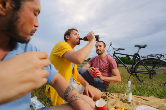 Friends Drinking at Outdoor Picnic