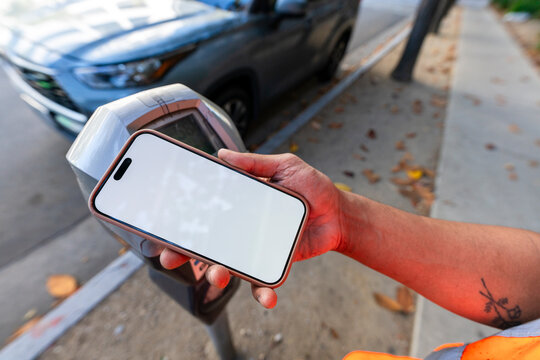 paying parking meter with cellphone tap to pay