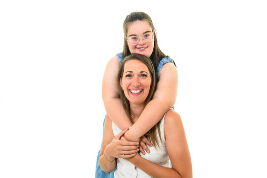 child girl with Down syndrome over white background with his mother