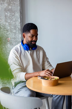 Businessman Working Remotely on Laptop With Headphones
