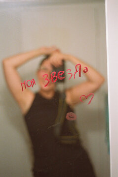 Love note in the mirror with a woman photographer's reflection