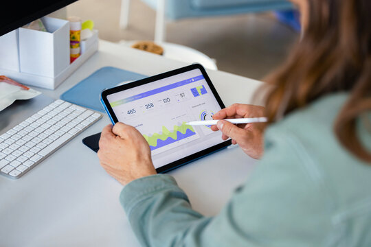 Business Analyst Reviewing Tablet Data Dashboard  