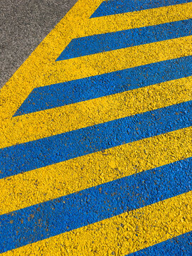 yellow and blue marked parking spot on the pavement