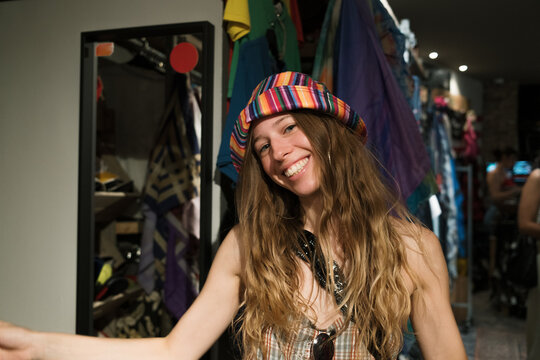Woman enjoys a moment while dancing in a colorful store