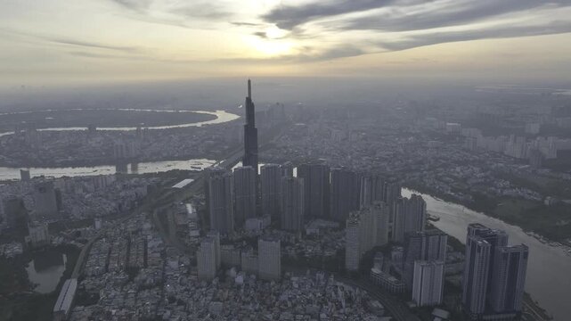 Aerial drone view of Landmark 81 in Thanh My Tay Ward, Ho Chi Minh City, Vietnam, with bright sunlight illuminating the iconic skyscraper and surrounding modern urban landscape.