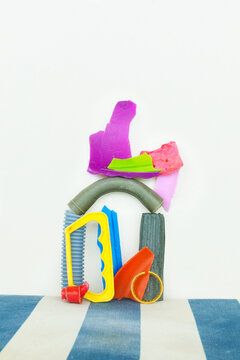 Sculpture with pieces of colourful plastic on a striped background 